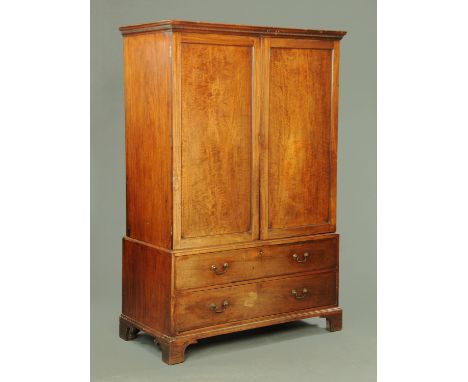 A George III mahogany linen cupboard, with moulded dentil cornice above a pair of well figured doors opening to hanging space