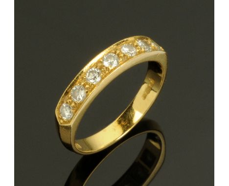 An 18 ct gold seven stone diamond ring, hallmarked, size N/O.  CONDITION REPORT: Weight 4 grams.