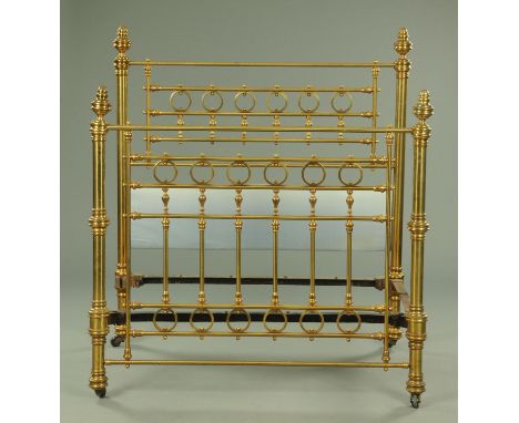 An Edwardian brass bed, complete with bed irons.  Width 140 cm. CONDITION REPORT: The height of the bed head including finial