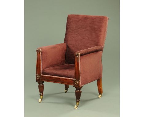 A Regency/William IV armchair, with angled back, upholstered arms, flat pilasters to each arm front and raised on short turne