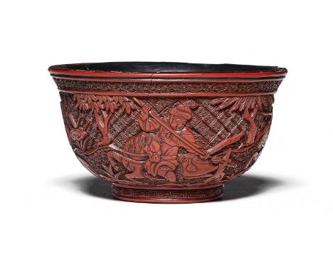 A RARE CARVED CINNABAR LACQUER 'HUNTING SCENE' BOWL16th/17th centuryThe rounded sides rising from a short foot to a flared ri