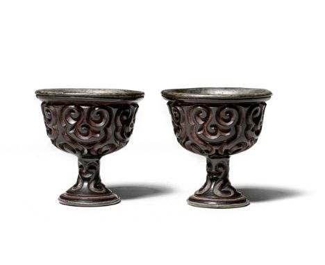 A PAIR OF CARVED TIXI LACQUER STEM CUPS16th centuryEach deeply carved around the exterior through layers of brown and red lac