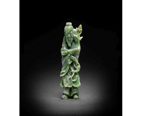 A SPINACH-GREEN JADE FIGURE OF LÜ DONGBINLate Qing DynastyThe tall bearded Daoist Immortal dressed in long flowing robes, a s