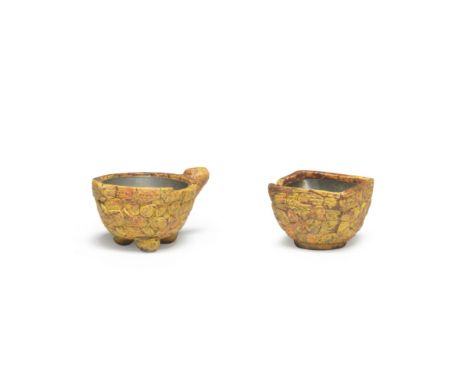 TWO EXCEPTIONALLY RARE REALGAR CUPS18th centuryOne of rounded square form, the other of stylised peach form, set on raised fe