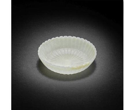 A MUGHAL-STYLE PALE GREEN JADE 'CHRYSANTHEMUM' DISH18th/19th centuryThe thin semi-translucent vessel delicately carved with r