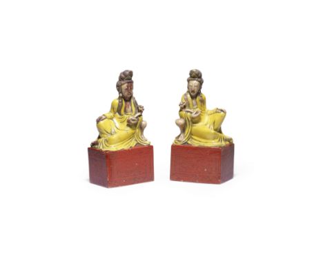 A PAIR OF PAINTED SOAPSTONE FIGURES OF GUANYINKangxiCarved in mirror image seated and propped up by an arm-rest, with one han