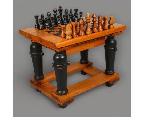 A 1970’s brutalist pine chess table by Brumblefly, with internal storage compartment holding the original chess set, with mak