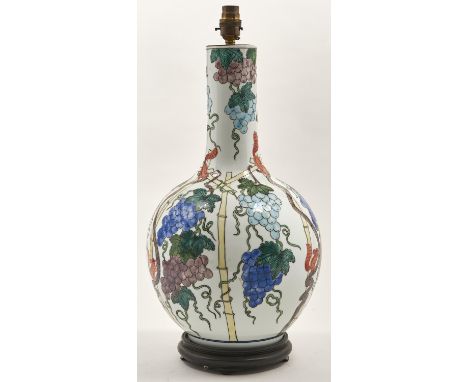 A porcelain bottle shaped vase, 20th c, decorated in Chinese 17th c style with squirrels and grapes between bamboo, mounted a