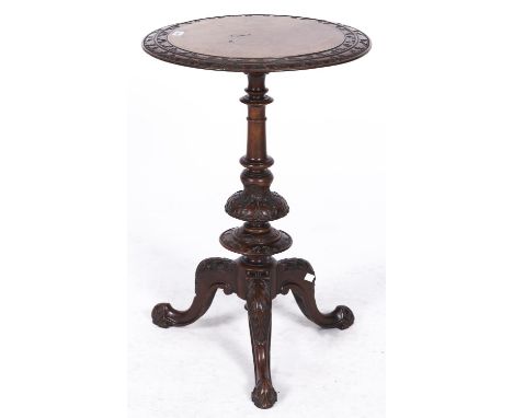 A Victorian carved and butterfly veneered walnut tripod table, 50cm diam 