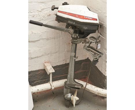 A Honda four stroke outboard engine and spare propeller 
