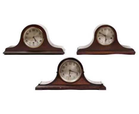 A mahogany cased mantel clock with walnut faced front, c1920, the swept case applied cockbeaded mouldings and turnings, the e