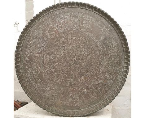 An Indian beaten brass tray with calligraphy to the centre, early 20th c, 66cm diam 