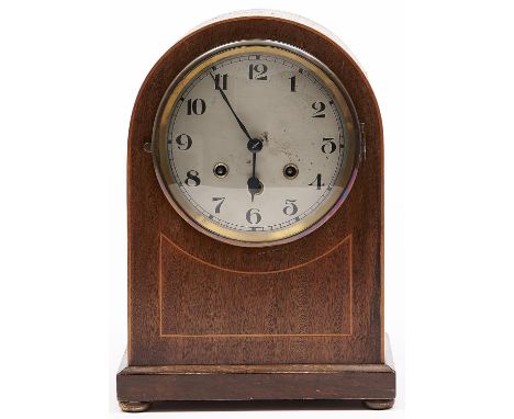 An inlaid mahogany domed top mantel clock, c1920, the case outlined with boxwood stringing, the silvered dial with Arabic num