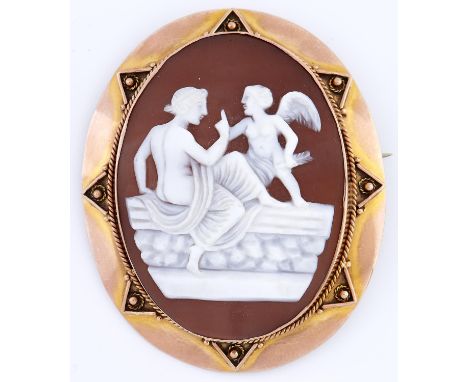 A cameo brooch, c1900, the oval shell carved with a maiden teasing cupid, in plain gold mount with applied decoration, 56mm, 