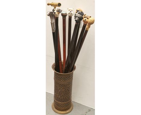Six walking sticks with resin dog's head pommels and four novelty sticks, one with cobra head terminal, another with bulls ey