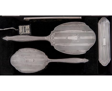 An Elizabeth II four piece silver brush set, engine turned, by W I Broadway &amp; Co, Birmingham 1964, cased 