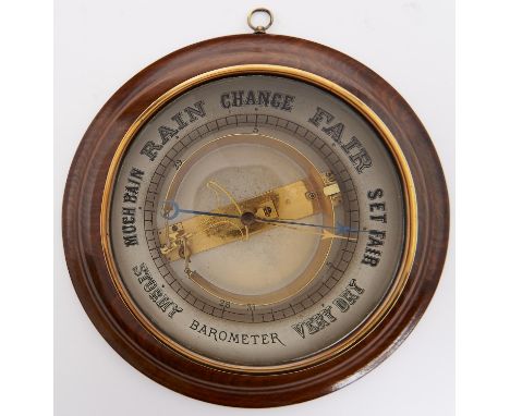 A walnut cased aneroid barometer, first quarter 20th c, the glass reverse printed in black with giltmetal movement inscribed 