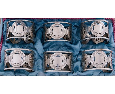 A set of six Chinese pierced silver napkin rings, early 20th c, with shou characters, maker T S and marked in Chinese, cased,