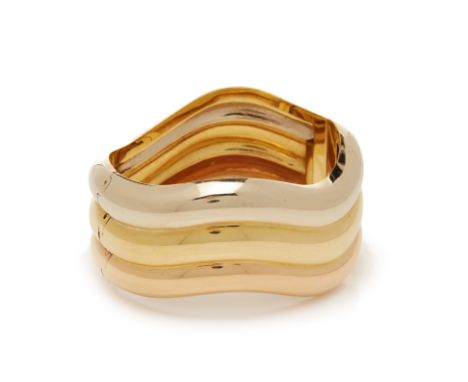 A THREE COLOUR GOLD HINGED BANGLE
To be sold with no reserve, from an estate collection of jewellery
In 18k gold, of wave des