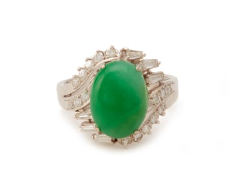 A WHITE GOLD DIAMOND AND CABOCHON JADE RING
The oval jade cabochon set within a surround of round brilliant and baguette cut 