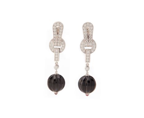 A PAIR OF CARTIER DIAMOND, ONYX AND RUBY 'AGRAFE' EARRINGS Set in white gold with circular cut diamonds to a fluted black ony