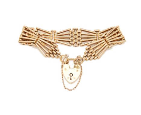 AN ANTIQUE 18K GOLD GATE LINK BRACELET
The heart shaped padlock clasp hallmarked for London, 1909, the gate links stamped "18