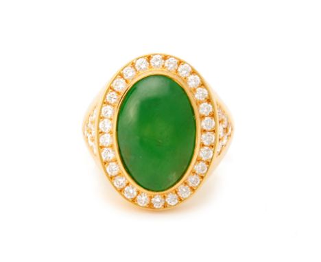 A DIAMOND AND CABOCHON JADE RING
Set in yellow gold, the oval green jade cabochon within a border of round brilliant cut diam