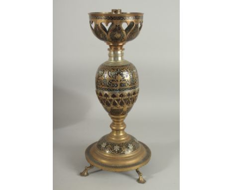 AN UNUSUAL MIXED METAL ENAMELLED BRASS LAMP, with central brass overlaid coconut, the circular base raised on four feet, 43cm