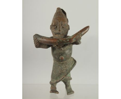 A RARE 19TH CENTURY OR EARLIER AFRICAN BENIN BRONZE FIGURE of a man holding a tusk, 17cm high.