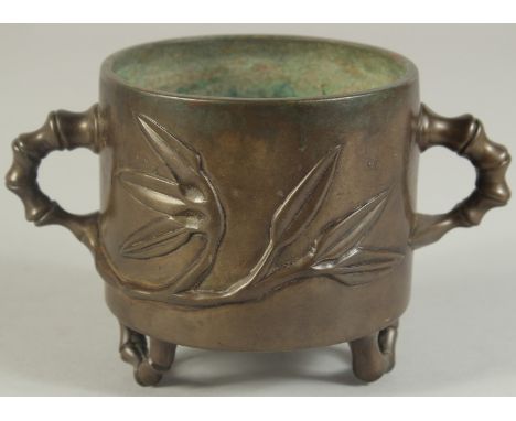 AN 18TH-19TH CENTURY CHINESE BAMBOO DESIGN BRONZE CENSER, with bamboo-form twin handles and raised on similar feet, the base 