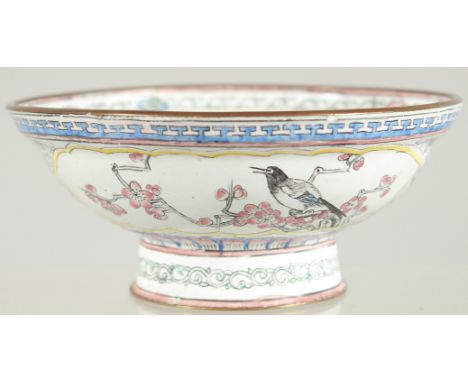 A 19TH CENTURY CHINESE CANTON ENAMEL BOWL, painted with panels of birds and native flora, 13cm diameter.