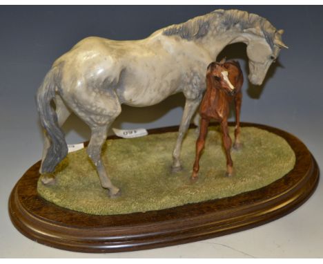 A Country Artists model Springtime, grey mare and foal mounted on a wooden plinth 