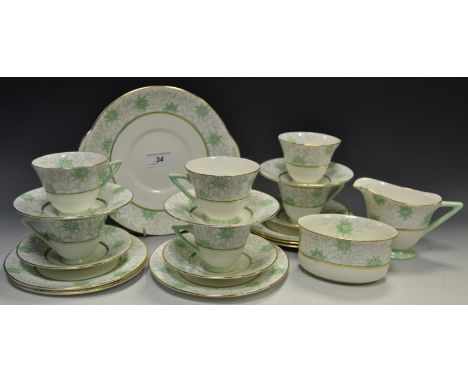 A Royal Doulton Art Deco tea service, for six, angular green hands, printed with stylised flowers in grey and green, printed 