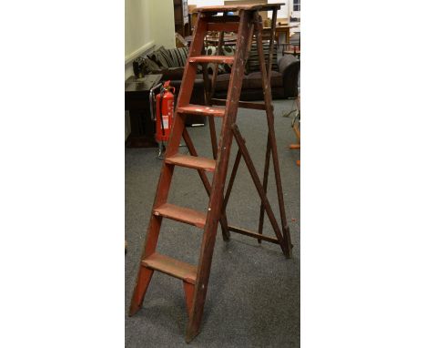 A set of pitch pine Jones's patent step ladders painted red 