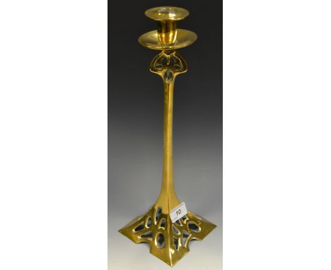 An early 20th century WMF style brass candlestick, the stem and base with pierced sinuous detail
