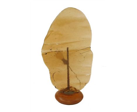 An amber glass slab light, on a turned wood plinth, 69.5cm high
