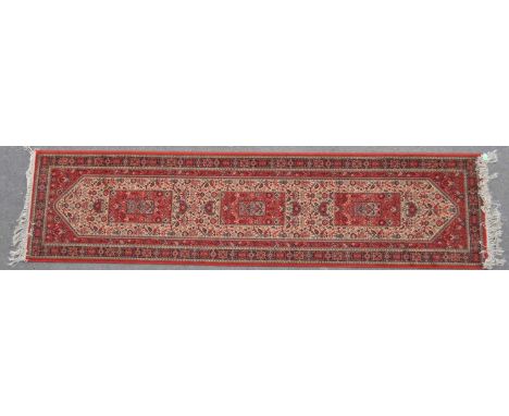 A vintage 20th century Persian Super Keshan carpet runner rug. The rug having a red ground, with large cream central field, f