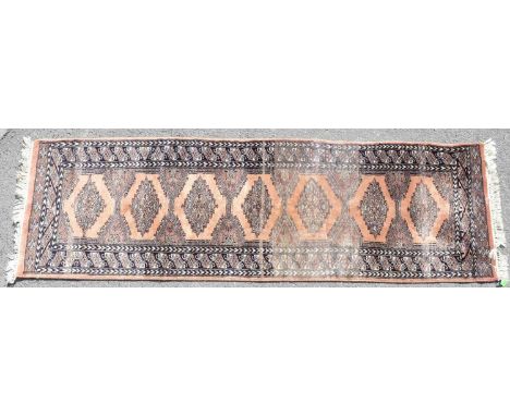 A vintage 20th century Persian Islamic carpet floor rug runner. With a series of repeating diamond medallions, encapsulated i