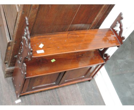 A late Victorian/Edwardian mahogany wall shelf having fret sides and cupboard underDIMENSIONSWidth 23"Depth 6"Height 24"