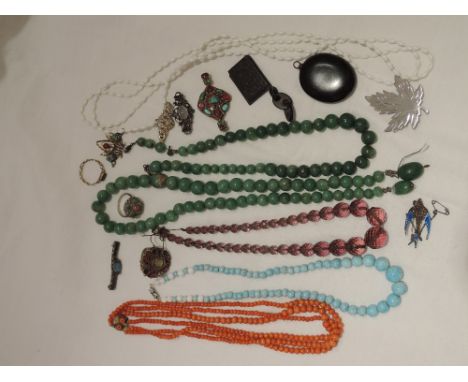 A selection of vintage costume jewellery and white metal brooches including jade style beads, mourning locket, coral beads, r