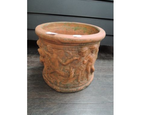 A 19th century terracotta garden planter having cherub decoration