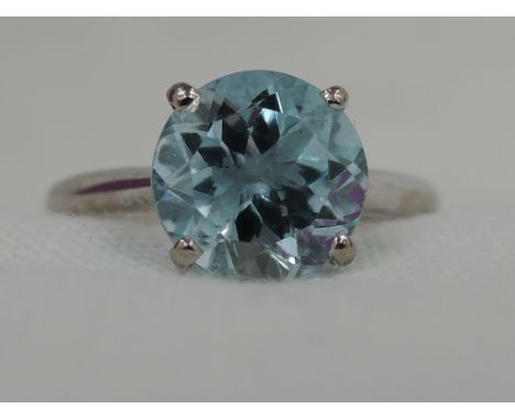 A lady's dress ring having an aqua marine style solitaire, approx 1.5ct in a 4 claw raised mount on an 18ct white gold loop, 