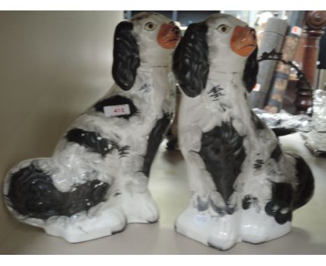 A pair of early 20th century Staffordshire mantel dogs of black and white designCONDITION REPORT,One restored and other has h