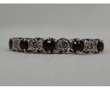 A lady's sapphire and diamond chip half eternity ring on a 9ct gold loop,  size O 