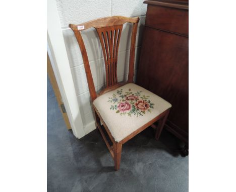 A pair of early 19th century light elm vernacular chairs having splay backs with later needlework seats, on square legs