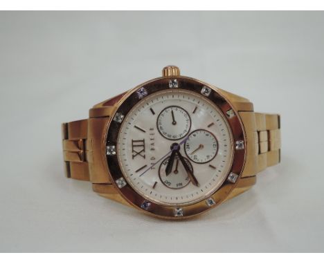 A lady's rose gold plated wrist watch by Ted Baker having a baton dial with a trio of inner dials on a mother of pearl face, 