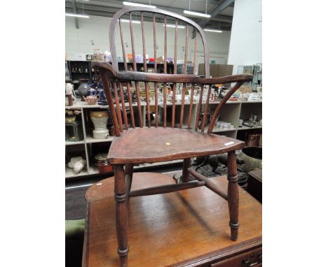 A 19th century Windsor armchair having comb back with solid seat and H stretcher