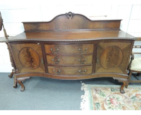 An early 20th century mahogany Chippendale revival sideboard having raised back and serpentine front with 3 central drawers f
