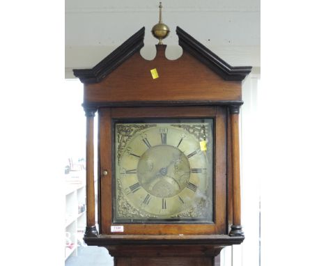 A late 18th century oak longcase clock having finial and shaped pillar hood containing square brass face and 30 hour movement