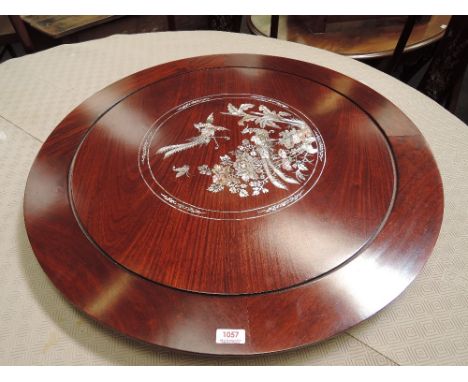 A late 20th century hardwood lazy susan having mother of pearl inlay decoration, in the Chinese taste